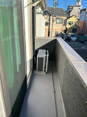 a balcony with an air conditioner on the side of a building at One Point Five in Tokyo