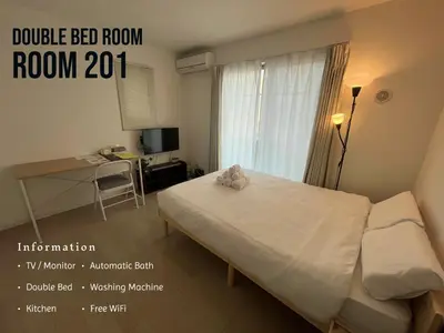 a small bedroom with a bed and a desk and a window at One Point Five in Tokyo