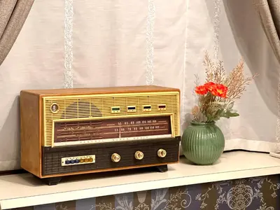 an old radio sitting on a shelf with a vase of flowers at S-asakusa -TT0418 in Tokyo