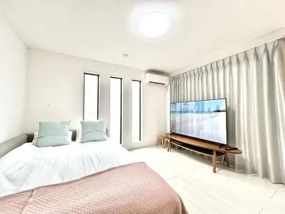 a bedroom with a bed and a flat screen tv at Shinjuku House-SJ0111 in Tokyo