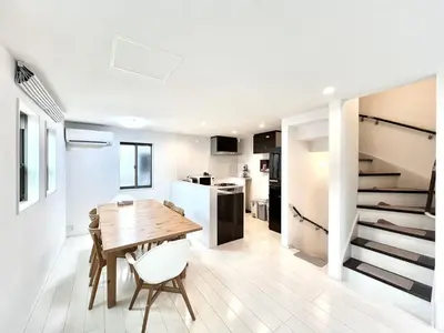 a kitchen and dining room with a wooden table and chairs at Shinjuku House-SJ0111 in Tokyo