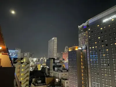 a city skyline at night with tall buildings at Dryokan Kabukicho in Tokyo