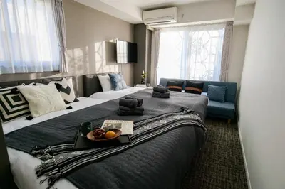a hotel room with a large bed with a bowl of fruit on it at Mr Kintaro Higashikomagata in Tokyo