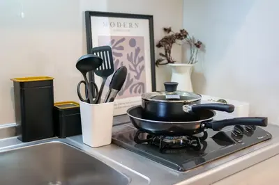 a pot on a stove next to a kitchen sink at Mr Kintaro Higashikomagata in Tokyo