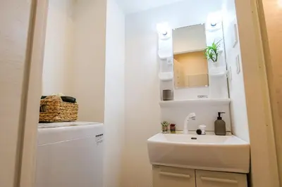 a small bathroom with a sink and a mirror at Mr Kintaro Higashikomagata in Tokyo