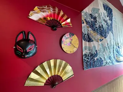 a wall with clocks and masks on a wall at Max4people Shinjuku 7minutes Shibuya12 minutes LEON RESORT SHIBUYA \u65b0\u5bbf\u6e0b\u8c37 \u6700\u5bc4\u308a\u521d\u53f0\u99c5 \u6700\u59274\u4eba in Tokyo