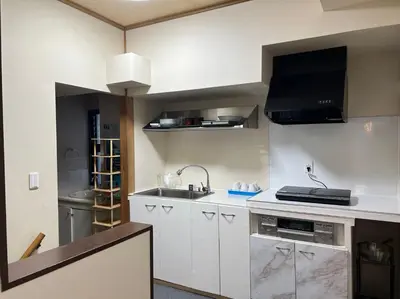 a kitchen with white cabinets and a sink at Le Tour Hotel Akihabara Kanda \u697d\u9014\u30db\u30c6\u30eb\u795e\u7530\u79cb\u8449\u539f in Tokyo
