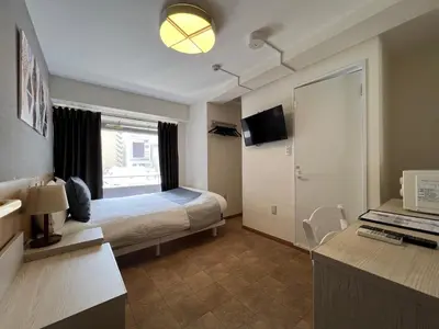 a hotel room with a bed and a television at Le Tour Hotel Akihabara Kanda \u697d\u9014\u30db\u30c6\u30eb\u795e\u7530\u79cb\u8449\u539f in Tokyo