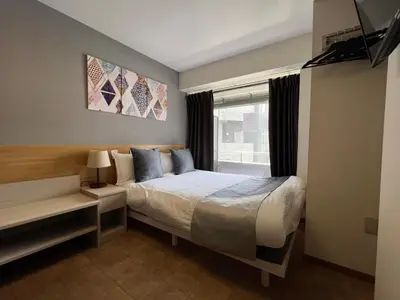 a bedroom with a large bed and a window at Le Tour Hotel Akihabara Kanda \u697d\u9014\u30db\u30c6\u30eb\u795e\u7530\u79cb\u8449\u539f in Tokyo