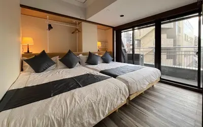 a large bed in a room with a large window at Le Tour Hotel Akihabara Kanda \u697d\u9014\u30db\u30c6\u30eb\u795e\u7530\u79cb\u8449\u539f in Tokyo