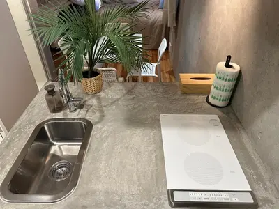 a kitchen counter with a sink and a cell phone on it at Style Lab\u5317\u5343\u4f4f in Tokyo
