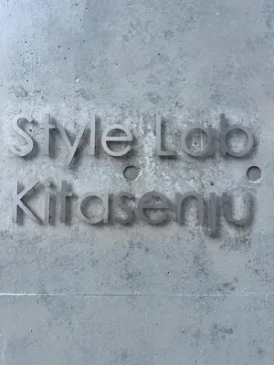 a sign on the side of a building at Style Lab\u5317\u5343\u4f4f in Tokyo