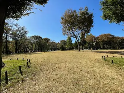 an empty field with a fence in a park at Reimei House Shinjuku 101 in Tokyo