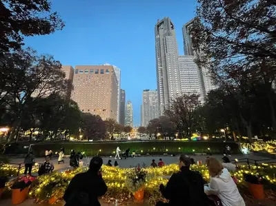 a group of people sitting in a park with lights at Reimei House Shinjuku 101 in Tokyo