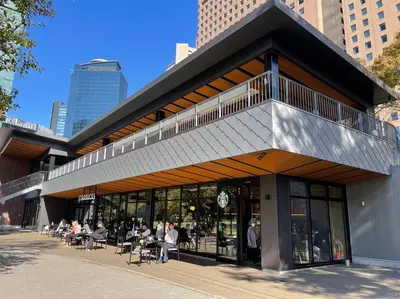 a building with people sitting outside of it at Reimei House Shinjuku 101 in Tokyo