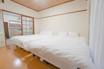 a large white bed sitting in a room at Reimei House Shinjuku 101 in Tokyo