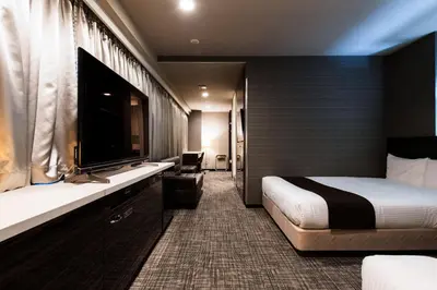 a hotel room with a bed and a large window at Urvest Hotel Kamata in Tokyo