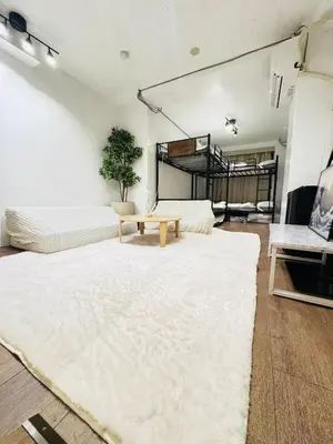 a living room with a large white rug at Shinjuku vista point in Tokyo