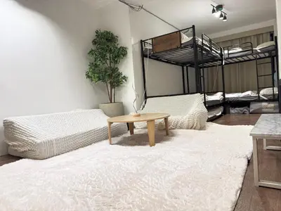 a living room with two beds and a table at Shinjuku vista point in Tokyo