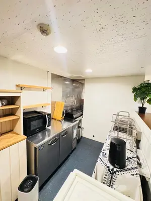 a room with a kitchen with a table and a counter at Shinjuku vista point in Tokyo