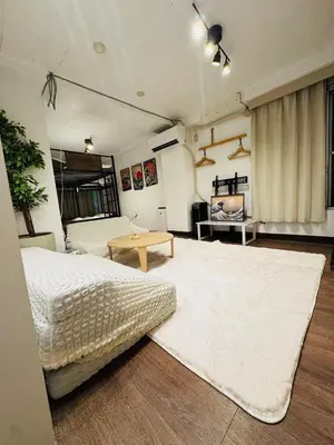a bedroom with a large bed and a table at Shinjuku vista point in Tokyo