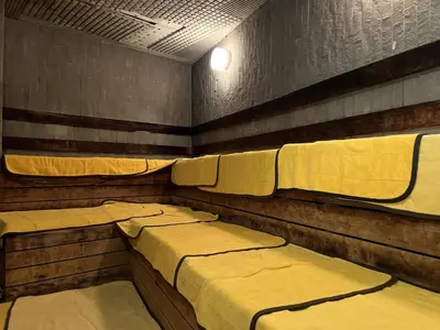 a room with three beds in it with at 男性専用サウナ&カプセル Men Only Capsule Room & Sauna, Bathhouse ミナミ下北沢 Minami Shimokitazawa in Tokyo