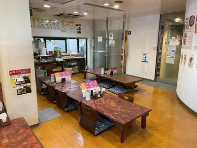 a restaurant with tables and chairs in a room at 男性専用サウナ&カプセル Men Only Capsule Room & Sauna, Bathhouse ミナミ下北沢 Minami Shimokitazawa in Tokyo
