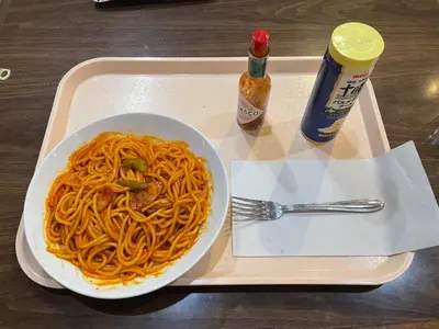 a tray with a bowl of spaghetti and a drink at 男性専用サウナ&カプセル Men Only Capsule Room & Sauna, Bathhouse ミナミ下北沢 Minami Shimokitazawa in Tokyo