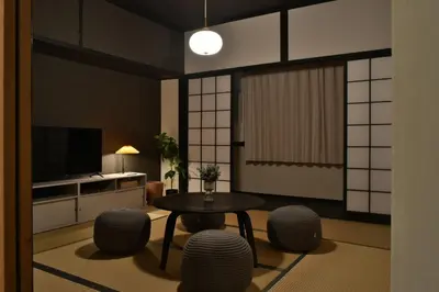 a living room with a table and some chairs at \u5ca1\u7530\u30d3\u30eb4\u968e in Tokyo