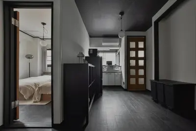 a bedroom with a bed and a kitchen and a mirror at \u5ca1\u7530\u30d3\u30eb4\u968e in Tokyo