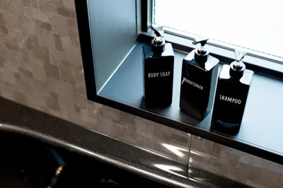 three bottles of soap sitting on a window sill at OLD HERITAGE SHIBUYA in Tokyo