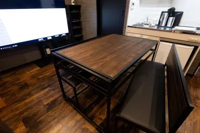 a wooden table and a television in a room at OLD HERITAGE SHIBUYA in Tokyo