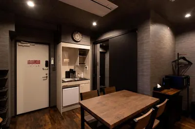 a dining room with a table and a clock on the wall at OLD HERITAGE SHIBUYA in Tokyo