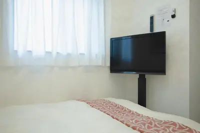 a flat screen tv sitting on top of a bed at QiQi Serenity Tokyo Exclusive New 3-Story Home, 14min to Skytree, Asakusa Area in Tokyo
