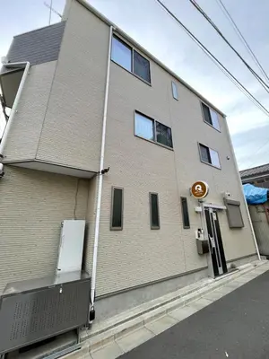 a brick building with a sign on the side of it at QiQi Serenity Tokyo Exclusive New 3-Story Home, 14min to Skytree, Asakusa Area in Tokyo