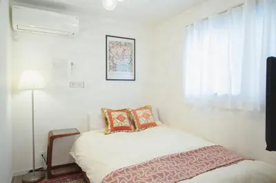a small bedroom with a bed and a window at QiQi Serenity Tokyo Exclusive New 3-Story Home, 14min to Skytree, Asakusa Area in Tokyo
