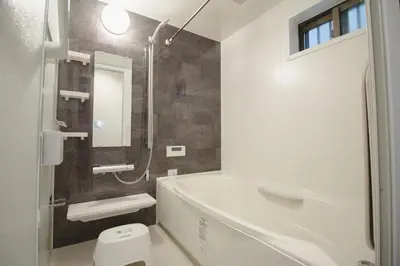 a bathroom with a white tub and a toilet at QiQi Serenity Tokyo Exclusive New 3-Story Home, 14min to Skytree, Asakusa Area in Tokyo