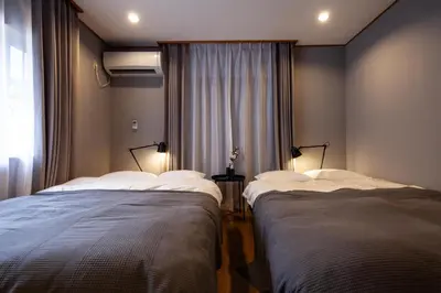 two beds in a room with a window at lucky aoto - Vacation STAY 16176 in Tokyo