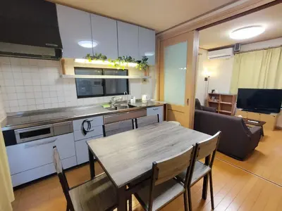 a kitchen and dining room with a wooden table at Lucky Higashi Mizue - Vacation STAY 16180 in Tokyo