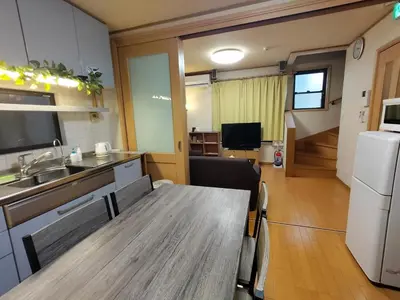 a kitchen with a wooden table in a room at Lucky Higashi Mizue - Vacation STAY 16180 in Tokyo