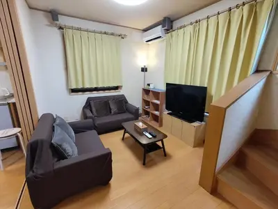 a living room with a couch and a television at Lucky Higashi Mizue - Vacation STAY 16180 in Tokyo