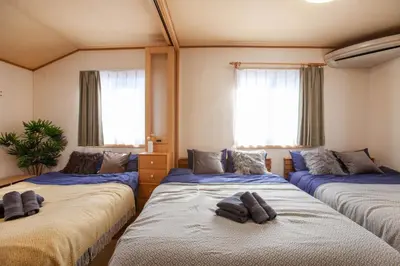 three beds in a room with windows at Lucky Higashi Mizue - Vacation STAY 16180 in Tokyo