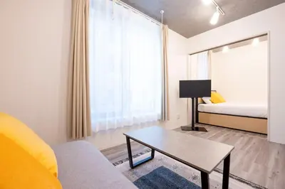 a living room with a bed and a coffee table at \u30a8\u30ea\u30af\u30b5\u30fc\u30e1\u30be\u30f3\u4ee3\u7530\u6a4b in Tokyo