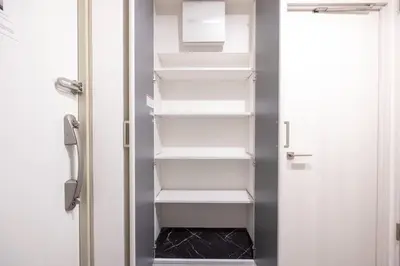 an open refrigerator door with white shelves in it at \u30a8\u30ea\u30af\u30b5\u30fc\u30e1\u30be\u30f3\u4ee3\u7530\u6a4b in Tokyo