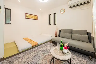 a living room with a couch and a bed at Ikebukuro house with 3BR Shinjuku 5min in Tokyo