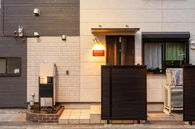 an entrance to a building with a pay phone at Ikebukuro house with 3BR Shinjuku 5min in Tokyo
