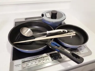 a frying pan and utensils on top of a stove at EMILIO158 - Quiet residential area near Shinjuku Free Wi-Fi in Tokyo