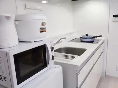 a white kitchen with a sink and a microwave at EMILIO158 - Quiet residential area near Shinjuku Free Wi-Fi in Tokyo
