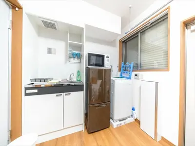 a kitchen with white cabinets and a refrigerator at Maison de Takinogawa - Vacation STAY 16164 in Tokyo