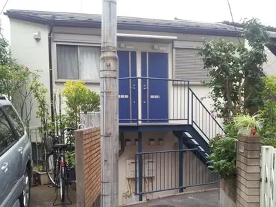 a house with a blue door and a staircase at Maison de Takinogawa - Vacation STAY 16163 in Tokyo